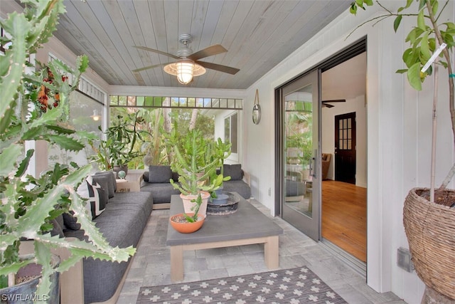 sunroom featuring wood ceiling and ceiling fan