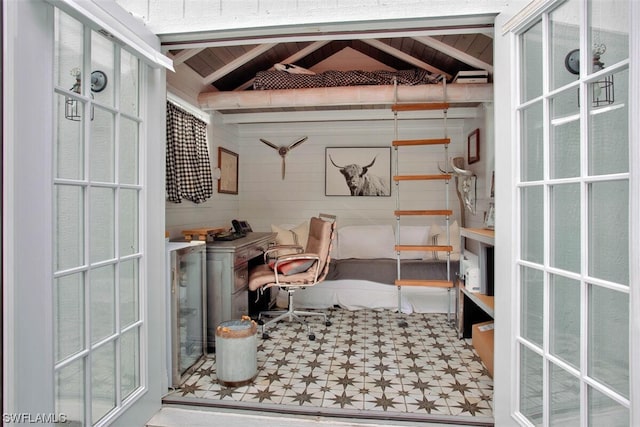 interior space featuring vaulted ceiling with beams, wood walls, wood ceiling, and tile patterned floors