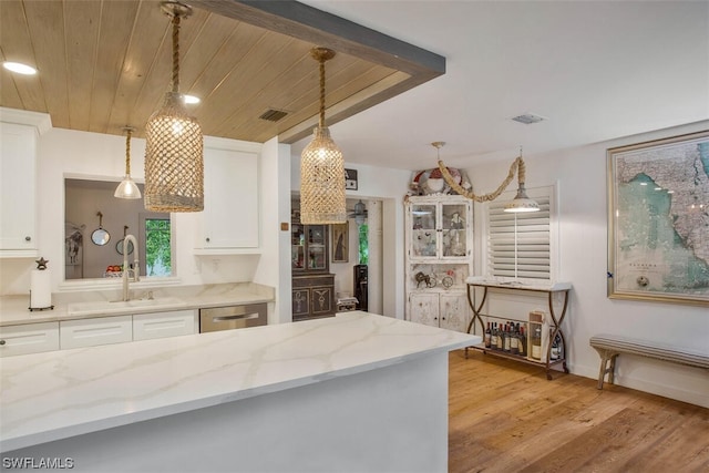 kitchen featuring white cabinets, visible vents, dishwasher, and light wood finished floors