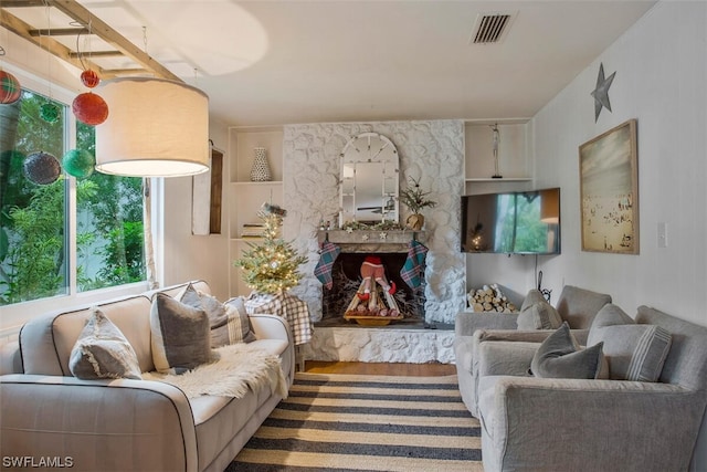 living room featuring visible vents and wood finished floors