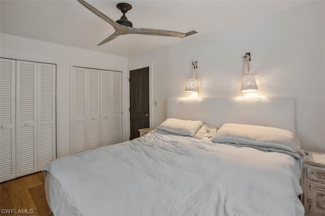 bedroom with a ceiling fan, light wood-style flooring, and two closets