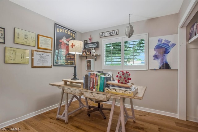 office space with baseboards and wood finished floors