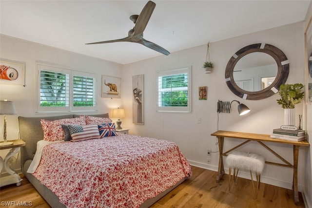 bedroom with baseboards, a ceiling fan, and wood finished floors