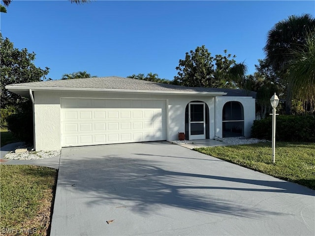 ranch-style home with a garage and a front yard