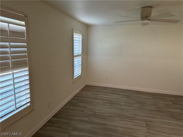 empty room featuring ceiling fan and dark hardwood / wood-style floors