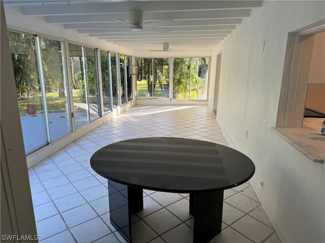 unfurnished sunroom with ceiling fan