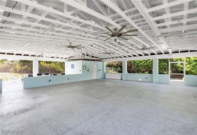 unfurnished sunroom with ceiling fan