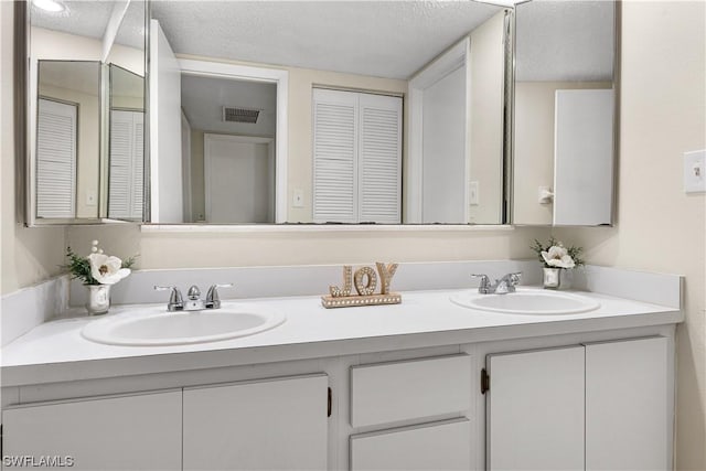 bathroom with vanity and a textured ceiling