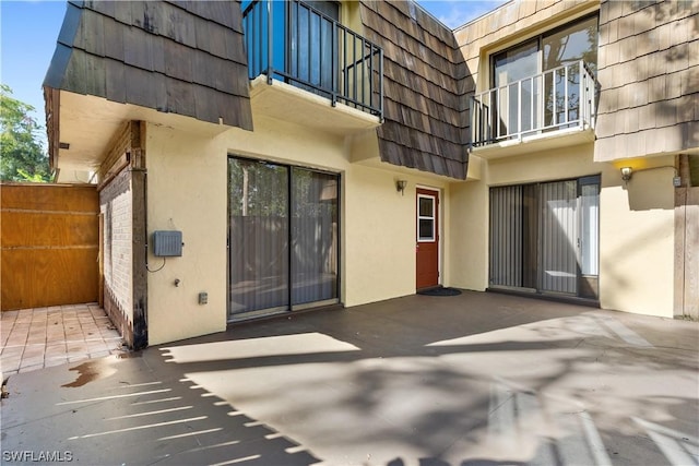 exterior space with a balcony and a patio