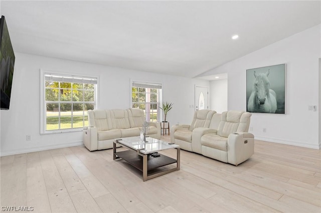 living room featuring light hardwood / wood-style floors and vaulted ceiling