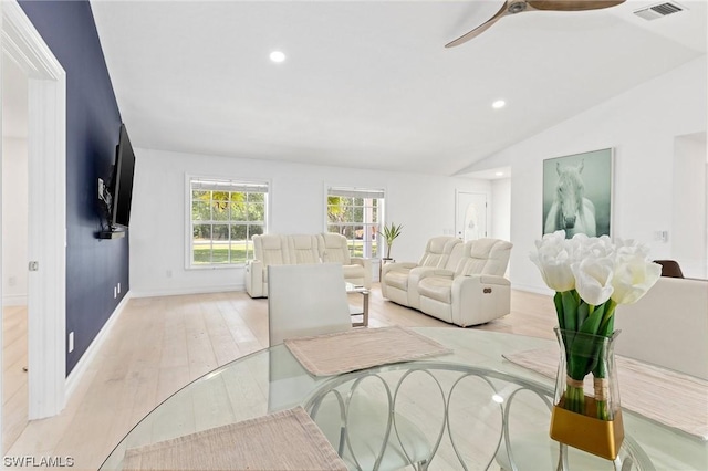 living room featuring light wood-type flooring, vaulted ceiling, and ceiling fan