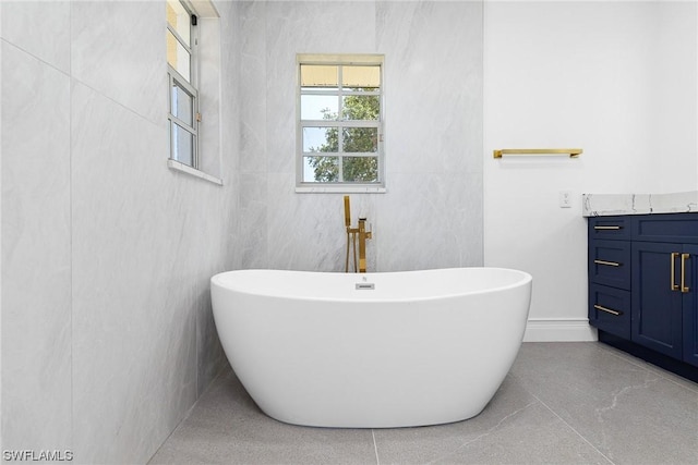 bathroom with a bath and tile walls