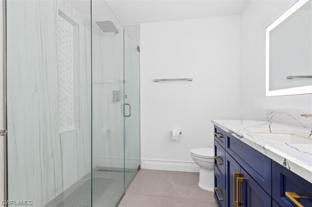 bathroom with toilet, vanity, tile patterned floors, and walk in shower