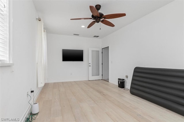 interior space with ceiling fan and light hardwood / wood-style flooring