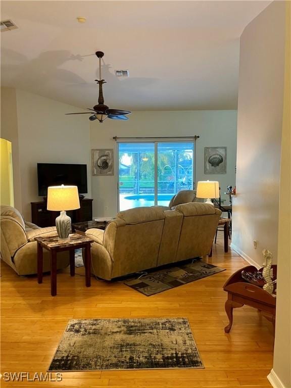 living room with light wood-type flooring and ceiling fan