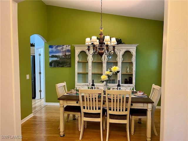 dining room featuring hardwood / wood-style flooring and an inviting chandelier