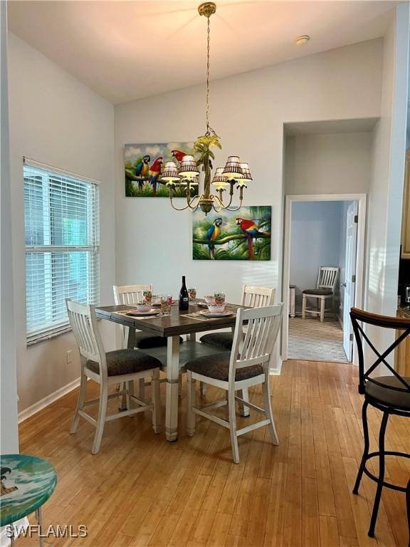 dining room featuring light hardwood / wood-style flooring and an inviting chandelier