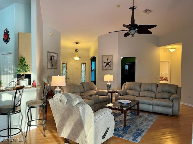 living room with ceiling fan and light hardwood / wood-style flooring