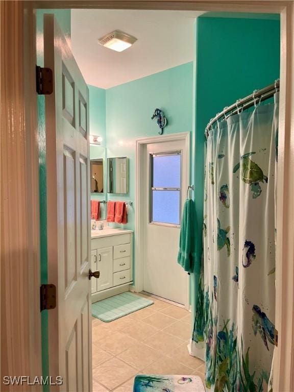 bathroom with vanity, a shower with curtain, and tile patterned floors