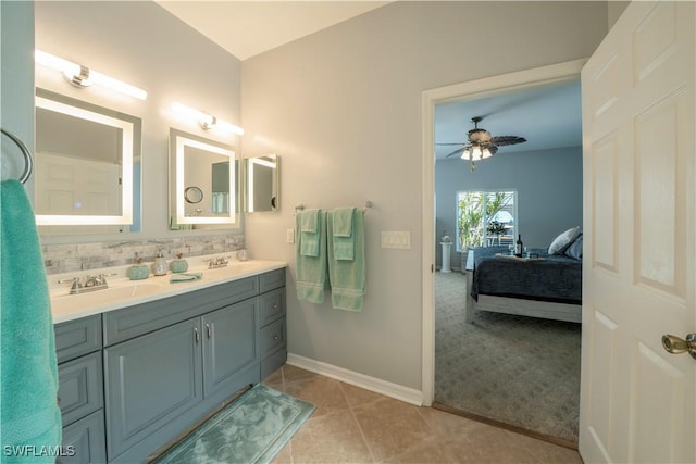 bathroom with ceiling fan, tile patterned flooring, vanity, and tasteful backsplash