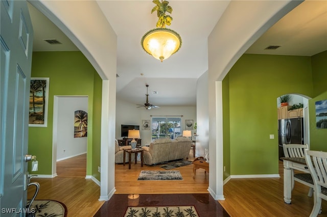 foyer entrance with hardwood / wood-style floors and ceiling fan