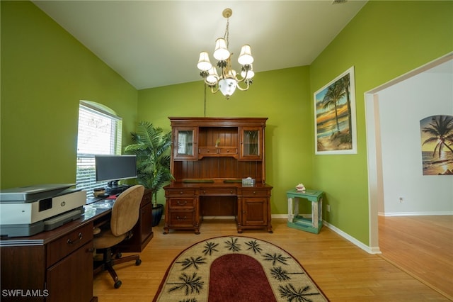 office space with light hardwood / wood-style floors, an inviting chandelier, and lofted ceiling