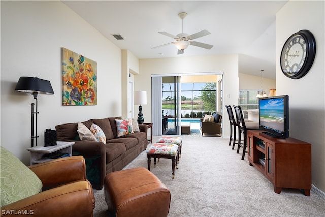 living room featuring lofted ceiling, light carpet, and ceiling fan