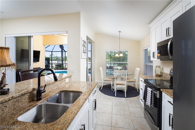 10038 Oakhurst Way, Fort Myers, FL 33913 - kitchen featuring electric range, freestanding refrigerator, stainless steel microwave, a sink, and lofted ceiling