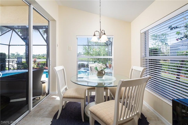 10038 Oakhurst Way, Fort Myers, FL 33913 - dining room featuring a chandelier, lofted ceiling, light tile patterned floors, and plenty of natural light