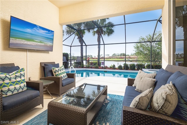 view of swimming pool featuring glass enclosure, an outdoor living space, and a patio area