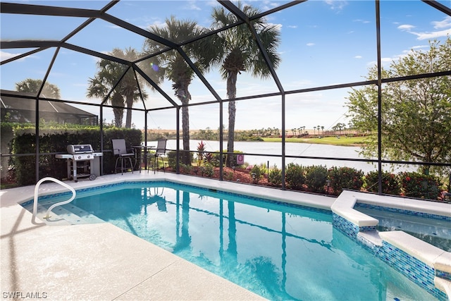 view of pool featuring glass enclosure, grilling area, a water view, and a patio