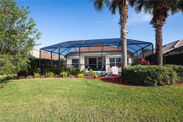 10038 Oakhurst Way, Fort Myers, FL 33913 - rear view of property featuring a tile roof, a yard, and stucco siding