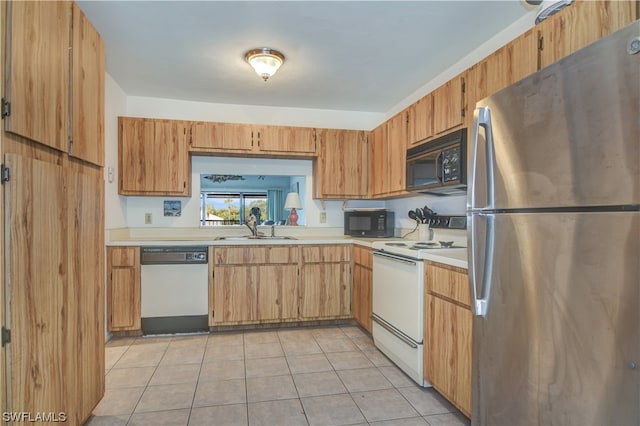 kitchen with light tile patterned flooring, white appliances, and sink