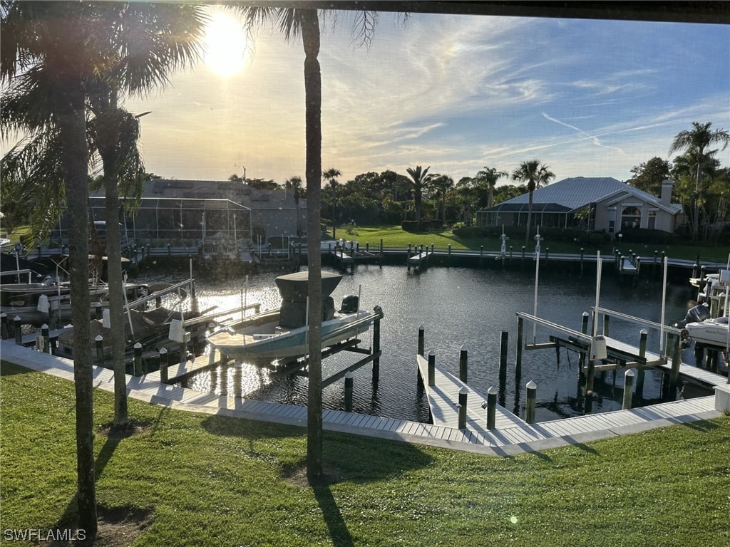 dock area with a yard and a water view