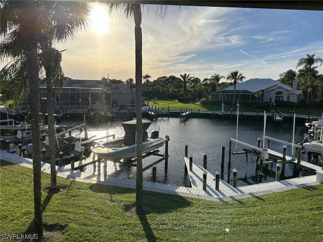 dock area with a yard and a water view