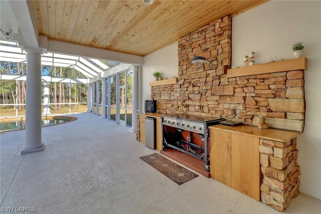 view of patio / terrace with area for grilling and a lanai