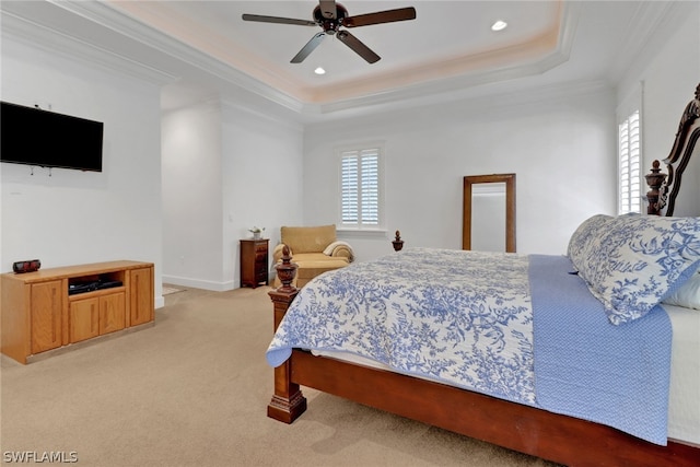 carpeted bedroom with ceiling fan, a raised ceiling, crown molding, and multiple windows