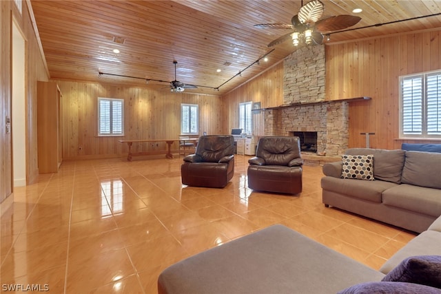 tiled living room with a fireplace, plenty of natural light, wooden ceiling, and wood walls