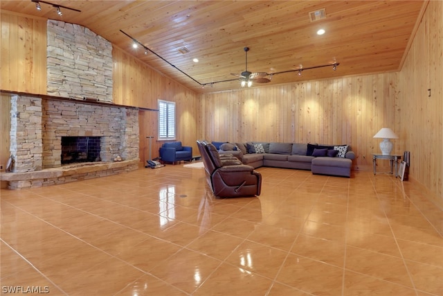 tiled living room featuring track lighting, wood ceiling, ceiling fan, high vaulted ceiling, and a stone fireplace