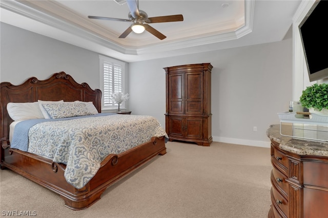 bedroom featuring ceiling fan, crown molding, light carpet, and a tray ceiling