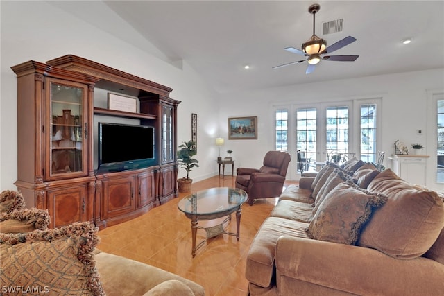 living room with ceiling fan, french doors, light tile patterned flooring, and vaulted ceiling