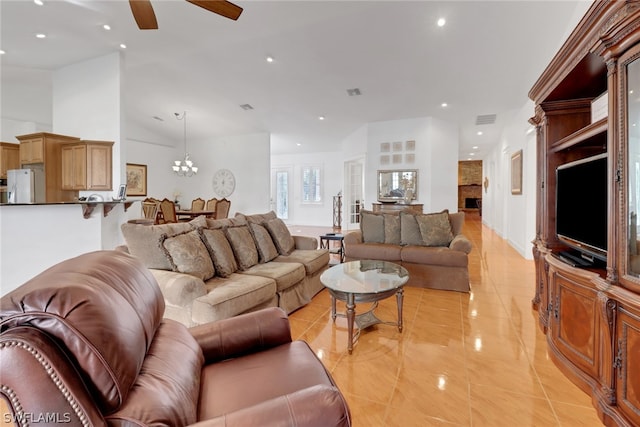 living room with light tile patterned floors and ceiling fan with notable chandelier