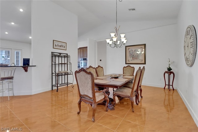 dining room featuring light tile patterned floors, vaulted ceiling, and a notable chandelier