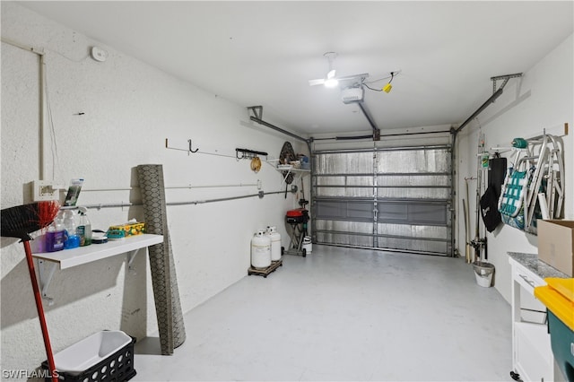 garage with a garage door opener and ceiling fan