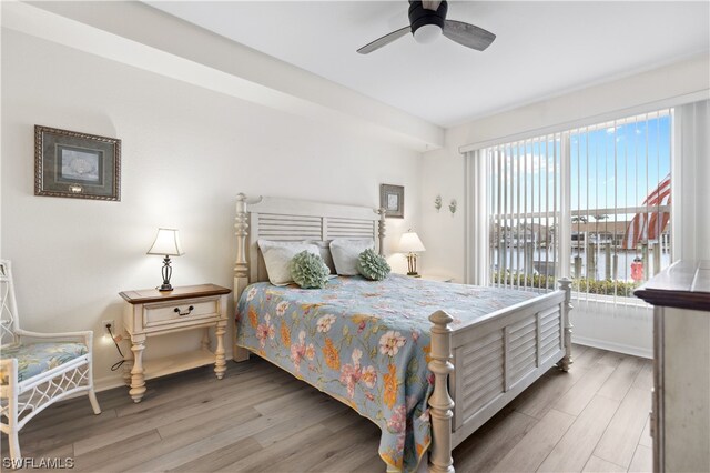 bedroom with light hardwood / wood-style floors and ceiling fan