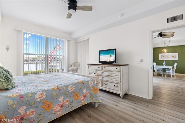 bedroom featuring access to outside, light hardwood / wood-style floors, and ceiling fan