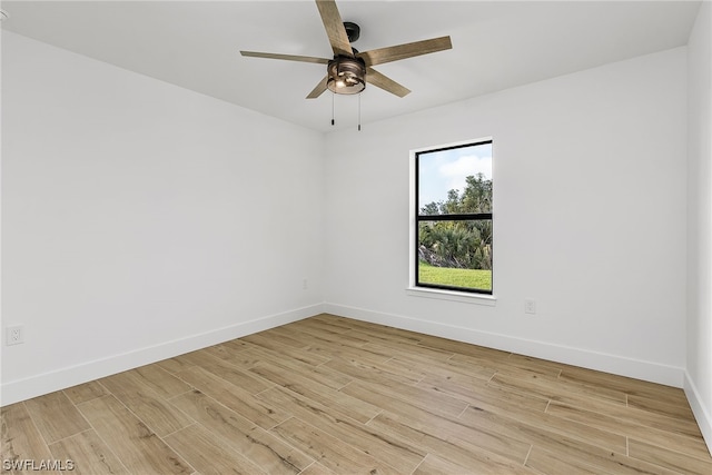 spare room with baseboards, ceiling fan, and light wood-style floors