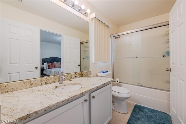 full bathroom featuring vanity, tile patterned flooring, toilet, and enclosed tub / shower combo