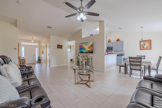 living room with ceiling fan, light tile patterned floors, and lofted ceiling