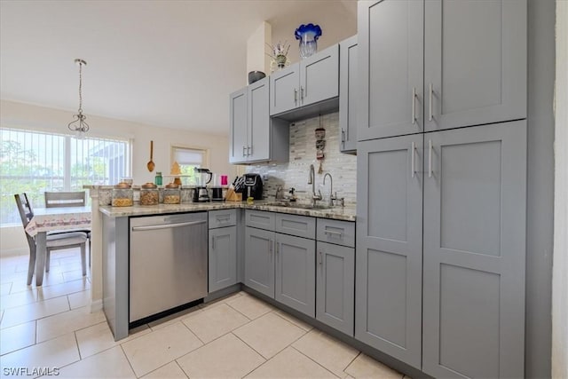 kitchen featuring kitchen peninsula, light stone countertops, sink, stainless steel dishwasher, and gray cabinets